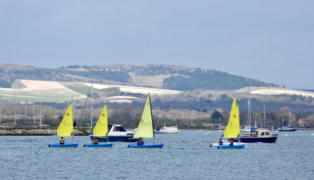 four blue sailing dinghies Chichester harbour